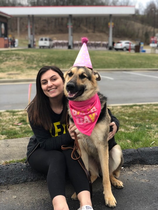 Team member Amber with her dog dressed for her birthday
